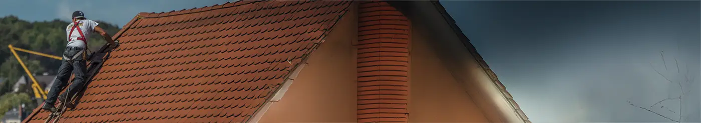 professional roofer is working on the top of a house roof