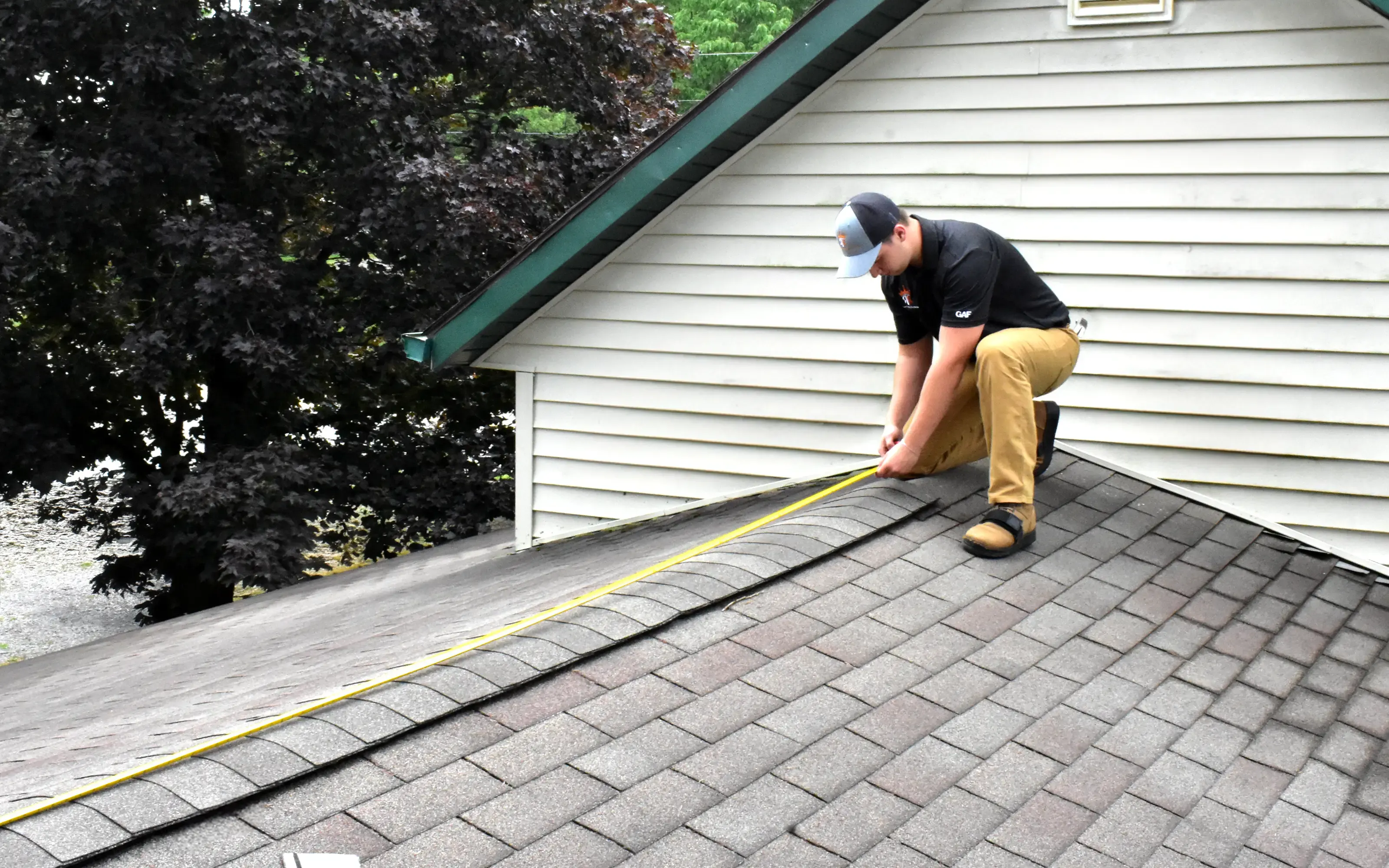 Alex Shestov takes the necessary measurements of the roof for further restoration after recent damage