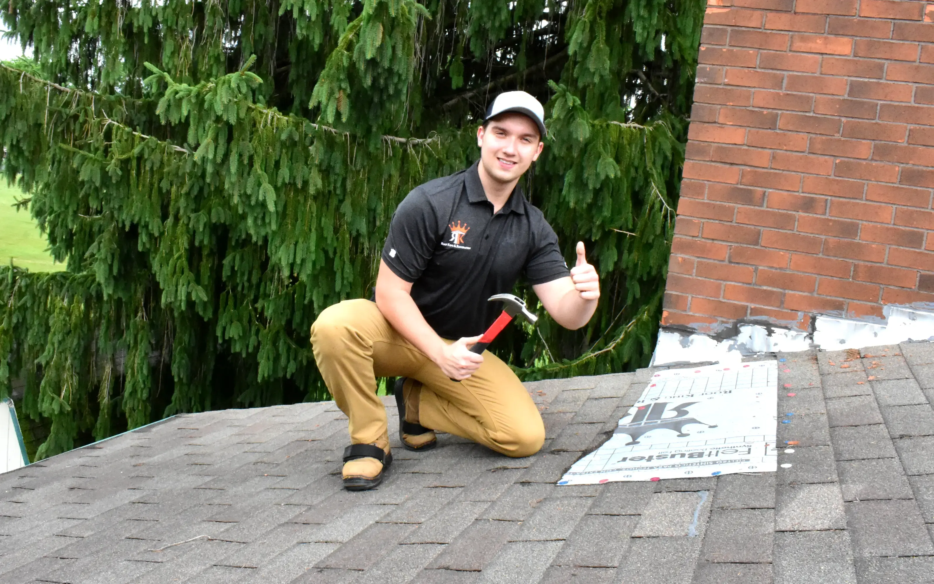 Alex Shestov temporarily covers damaged areas of the roof for protection for further restoration after recent damage
